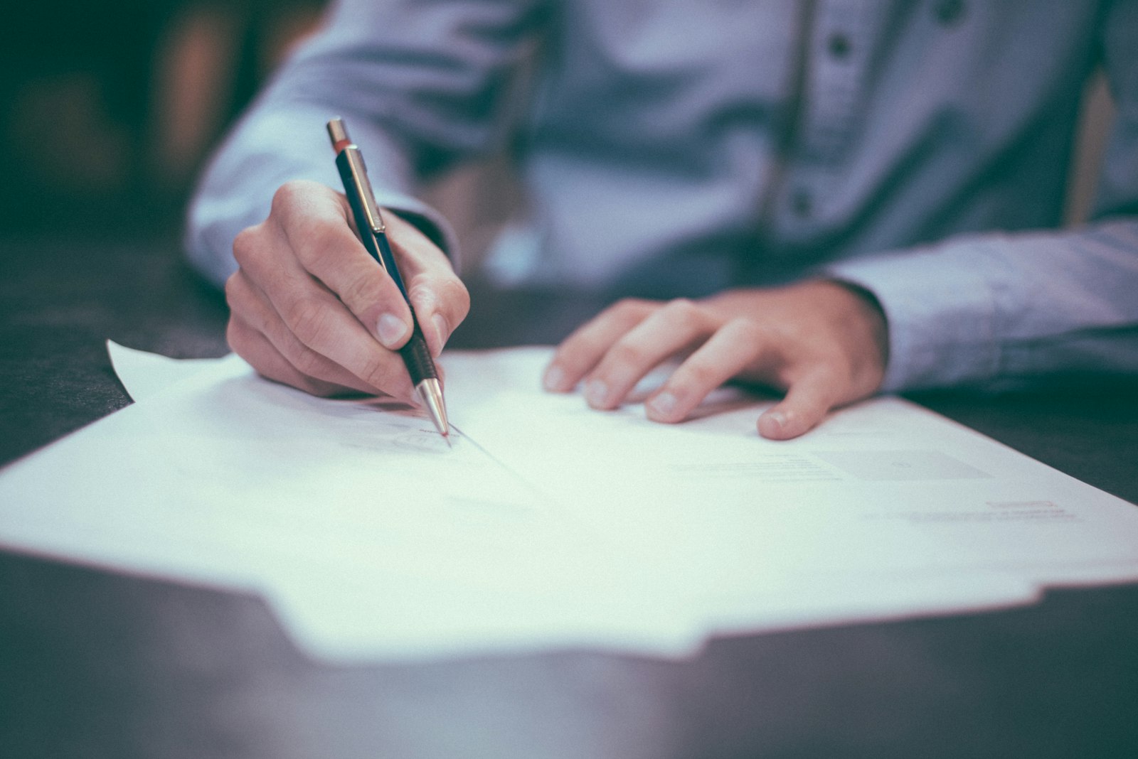 Claim paperwork — hands on a desk